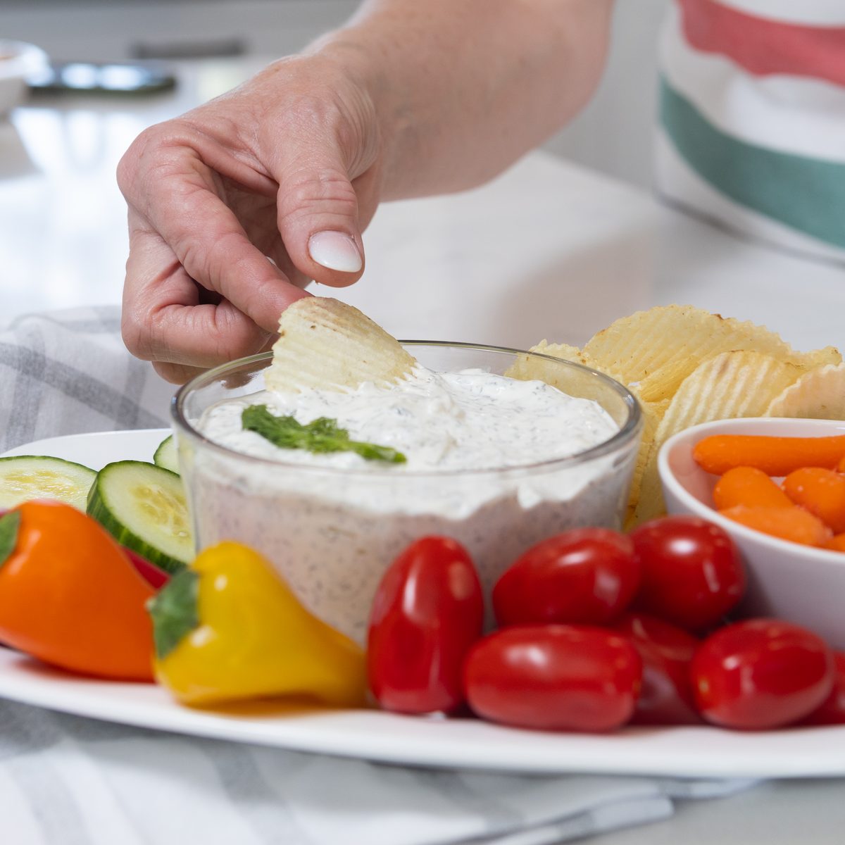 Patti dipping a chip into a fresh bowl of dip